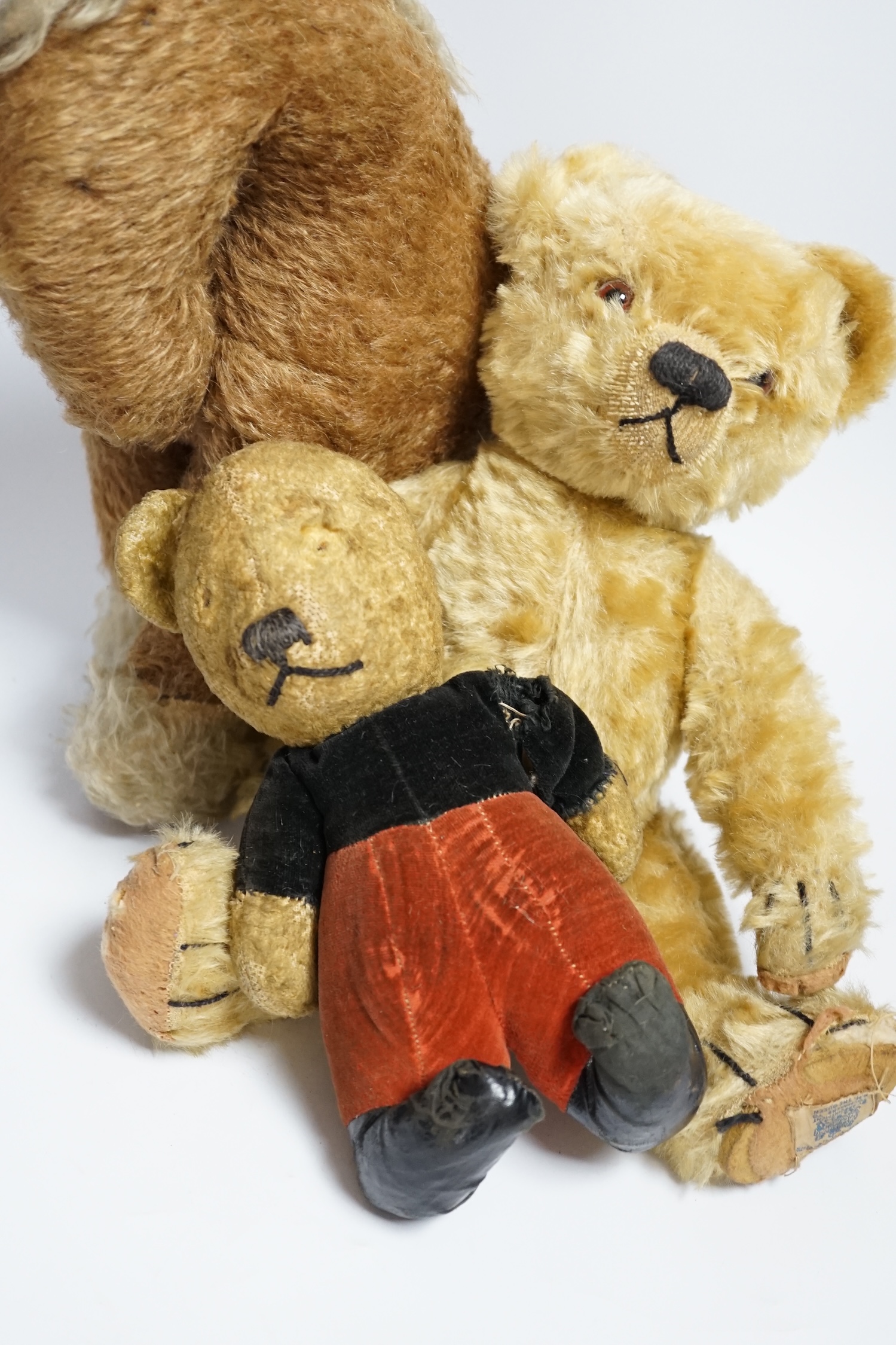 A Chad Valley teddy bear, 34cm high, a smaller bear in velvet clothes and a Merrythought horse